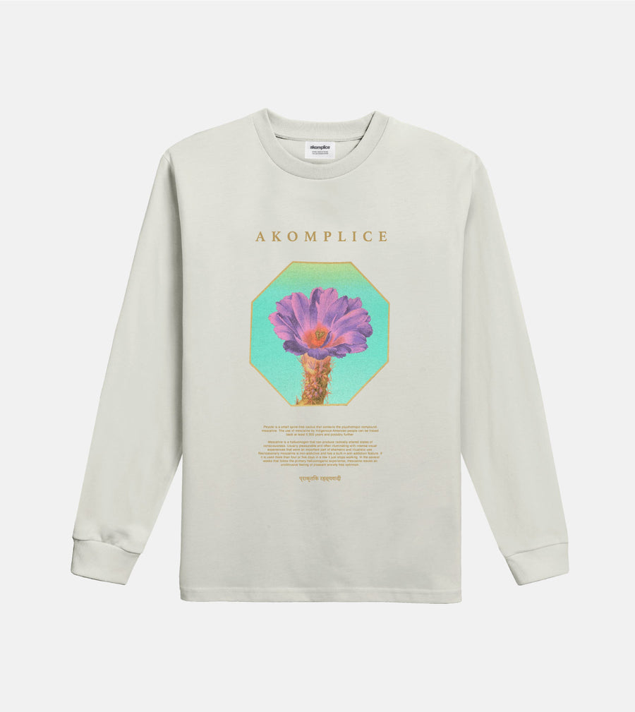 Beige long-sleeve shirt with a graphic design and 'Akomplice' branding on a white background