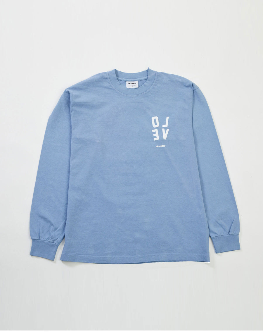 Blue long-sleeve shirt with white text on a light gray background