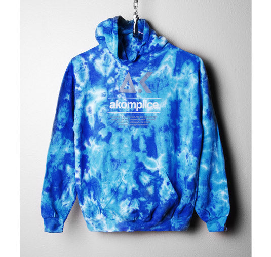 Blue tie-dye hoodie with 'akomplice' logo on a gray background
