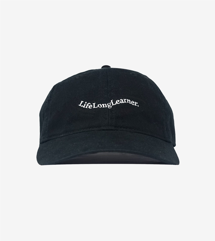 Black cap with 'Lifelong Learner' text on a light gray background