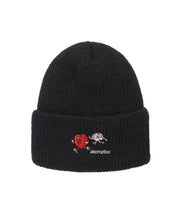 Black beanie with red and white design and 'akomplice' branding on a white background