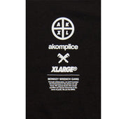 Black t-shirt with white text and logos including 'akomplice' and 'XLarge'.