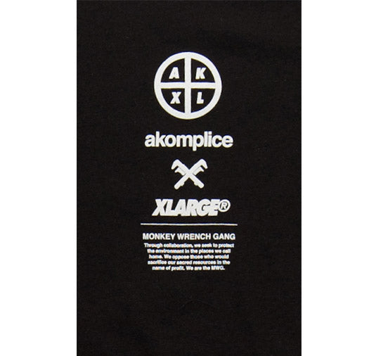 Black t-shirt with white text and logos including 'akomplice' and 'XLarge'.