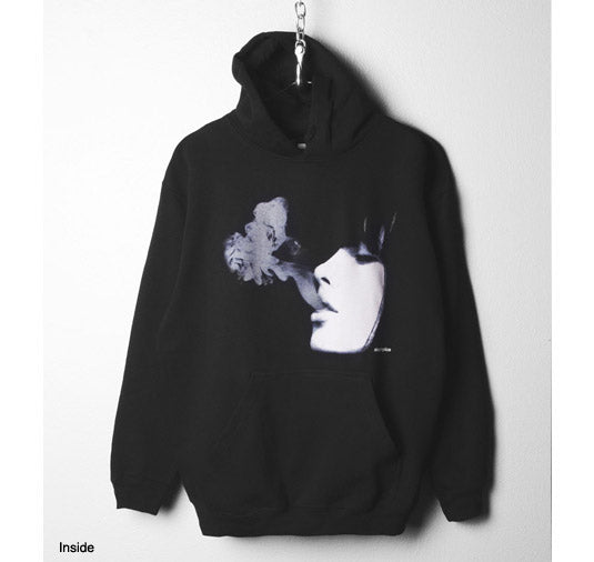 Black hoodie with a graphic design of a face and flower on a white background