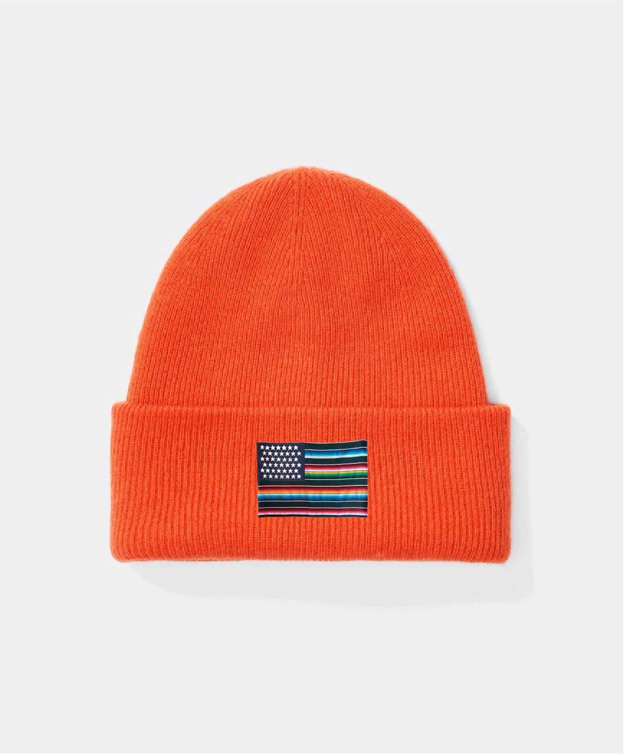 Orange beanie with a small flag patch on a light gray background