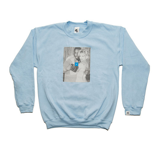 Light blue sweatshirt with a graphic design on a white background