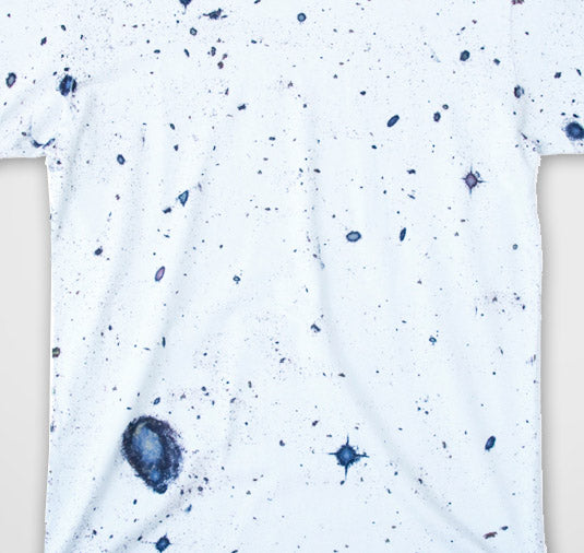White t-shirt with blue speckles on a white background